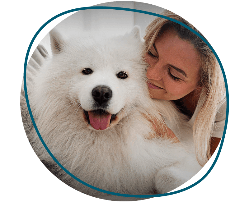 woman hugging her corgi dog